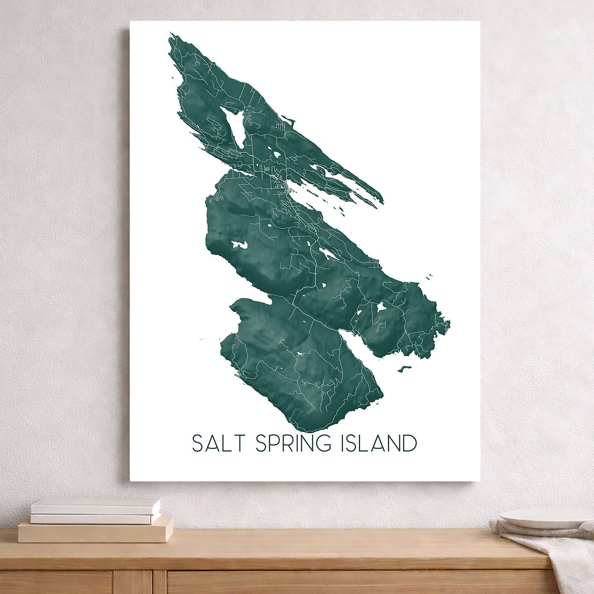 Salt Spring Island map art print displayed on a wall, featuring a green coastal BC island map design.