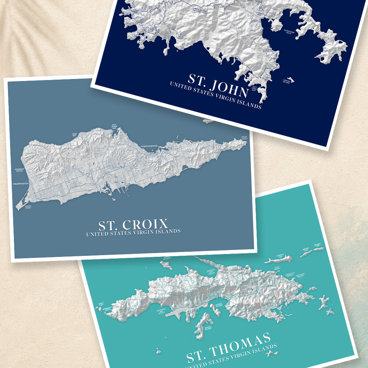 Three Caribbean island map prints featuring St. John, St. Croix, and St. Thomas displayed in layered coastal colours.