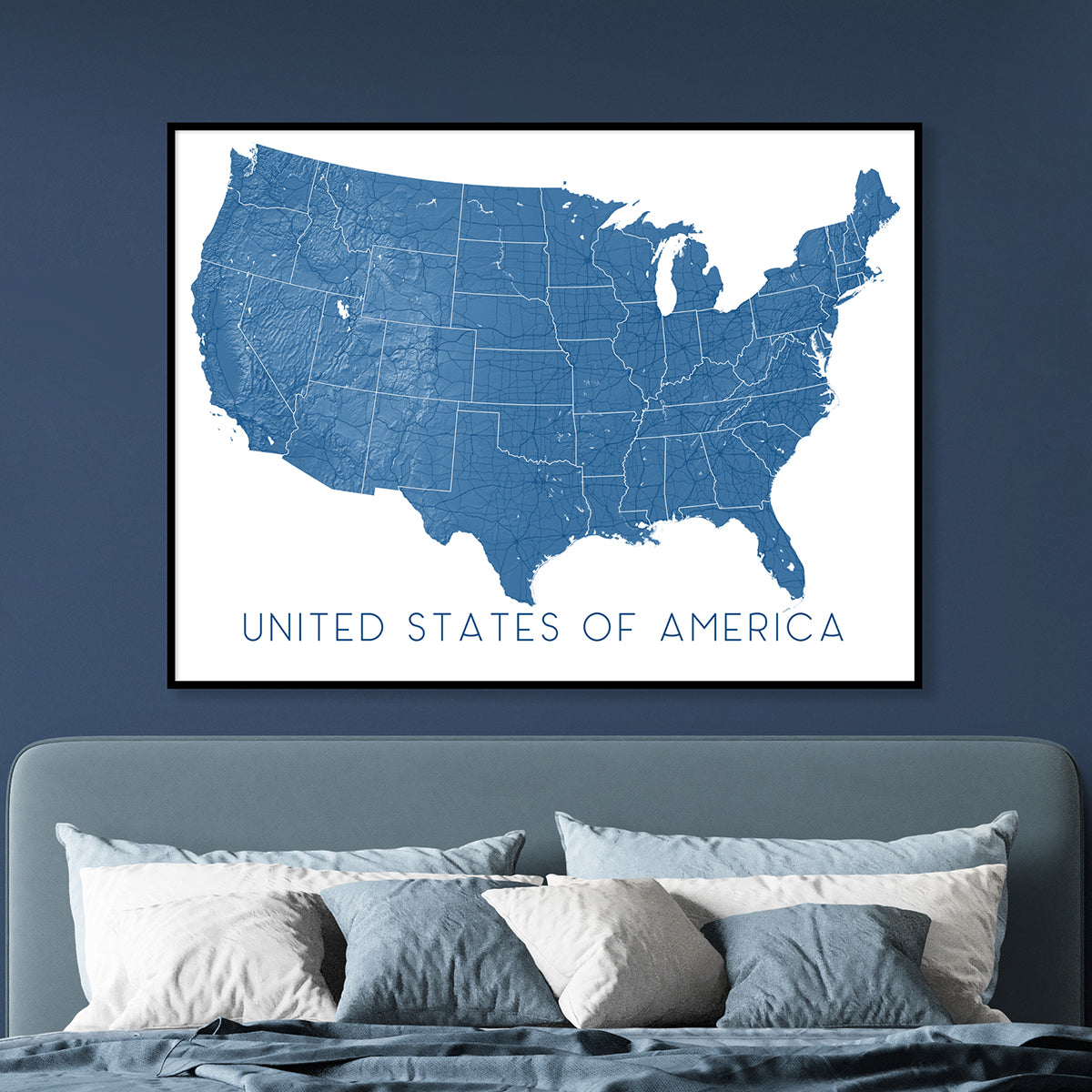 USA map art print in blue displayed as bedroom wall art, featuring a detailed United States map poster.