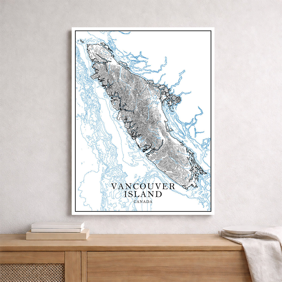 Vancouver Island map print shown framed on a wall above a wooden console table.