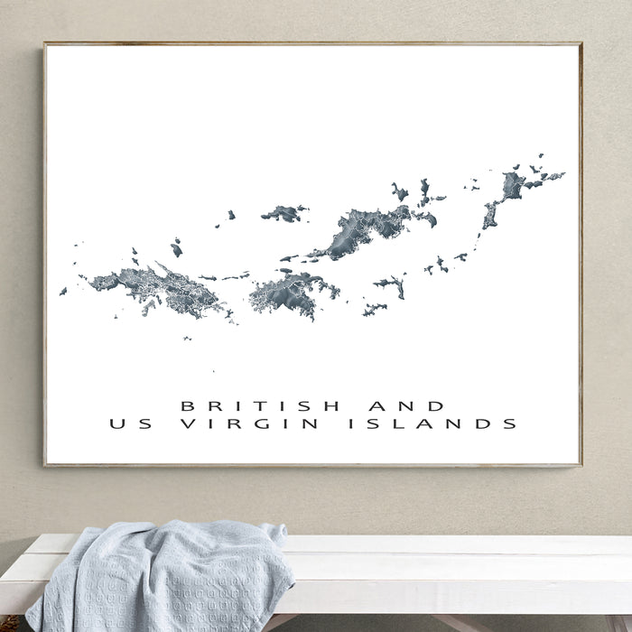 Map of British and US Virgin Islands framed on a wall above a white bench.