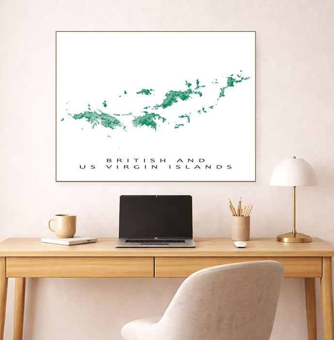 Framed map of British and US Virgin Islands above a desk with a laptop and lamp.