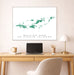 Framed map of British and US Virgin Islands above a desk with a laptop and lamp.