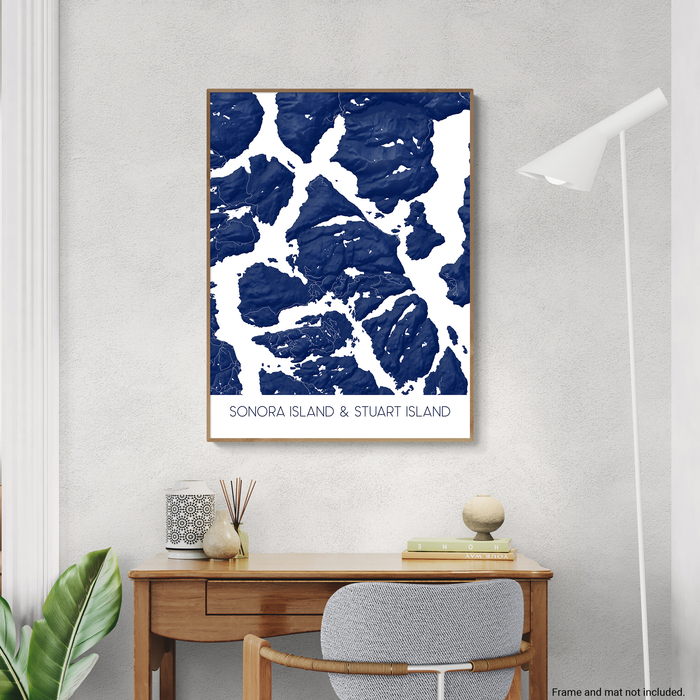 Framed map of Sonora Island & Stuart Island on a wall above a desk.