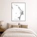 Framed map of Abaco Islands on a wall above a bed in a bedroom.