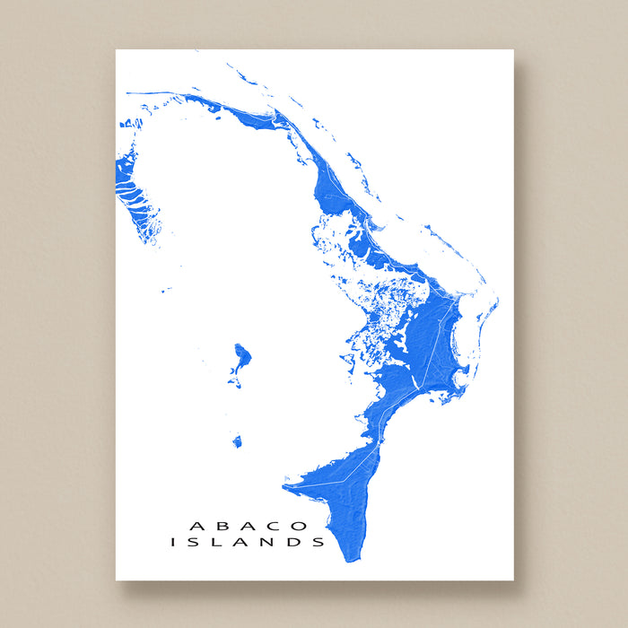 Map of Abaco Islands in blue on a white background, framed against a beige wall.