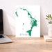 Map of Abaco Islands on a white background, displayed on a wooden desk with a laptop and plant.