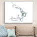 Framed map of Abaco, The Bahamas on a wall above a beige sofa with light blue pillows.
