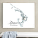 Framed map of Abaco, The Bahamas on a wall above a bench.