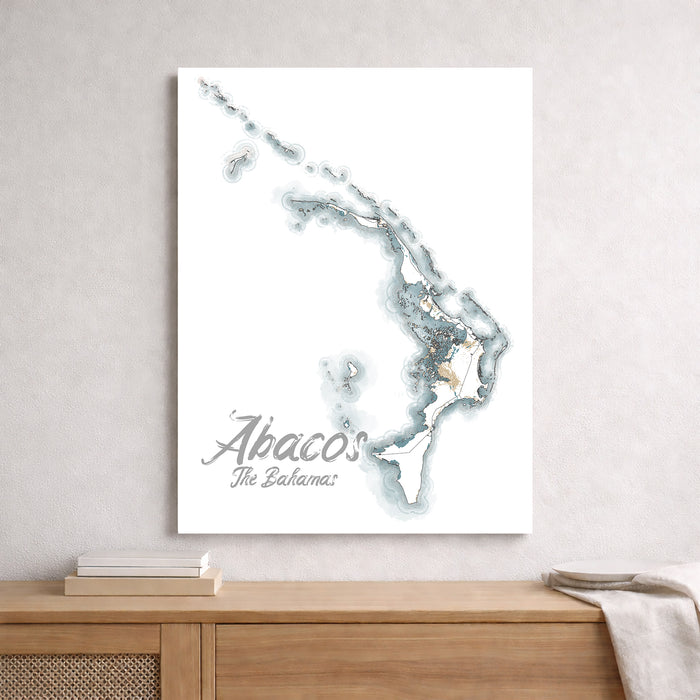 Map of Abaco, The Bahamas on a white wall above a wooden shelf.
