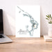 Map of Abacos, The Bahamas on a desk with a laptop and plant.