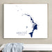 Framed map of Abacos, The Bahamas on a wall above a white bench.