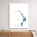 Map of Abacos, The Bahamas on a white wall above a wooden shelf.