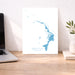 Map of Abacos, The Bahamas on a desk with a laptop and plant.