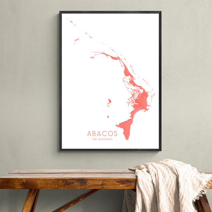 Framed map of Abacos on a wall above a wooden bench.
