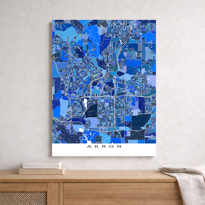Map of Akron in blue tones on a white wall above a wooden surface.