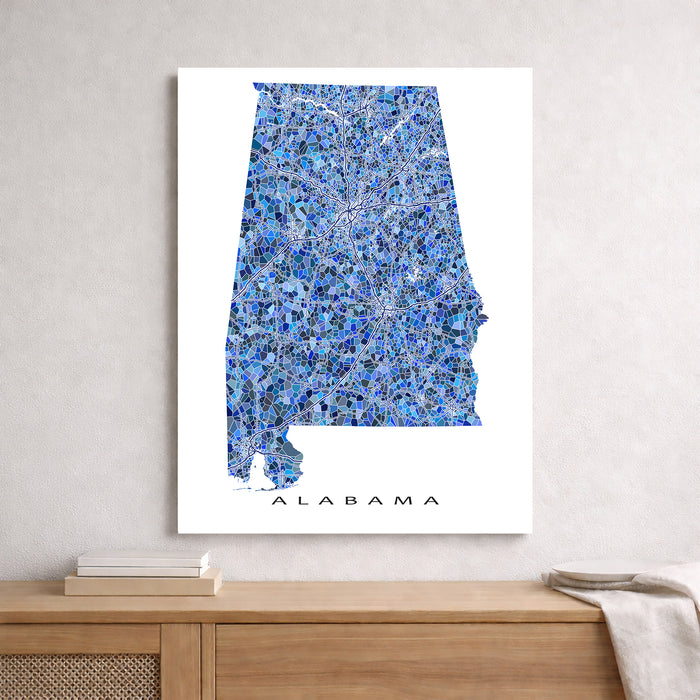 Map of Alabama on a white background, framed above a wooden surface.