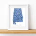 Framed map of Alabama with a blue watercolor design on a white background