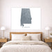 Map of Alabama on a wall above a bed in a bedroom setting