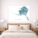 Map of Alaska on a wall above a bed in a bedroom