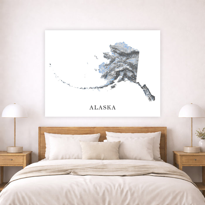 Map of Alaska on a wall above a bed in a bedroom