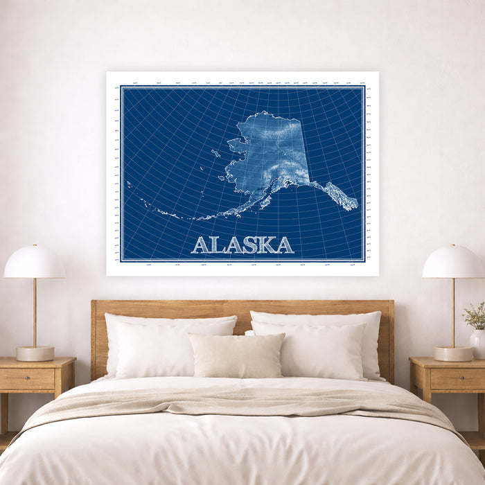 Framed map of Alaska on a wall above a bed in a bedroom.