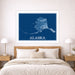 Framed map of Alaska on a wall above a bed in a bedroom.