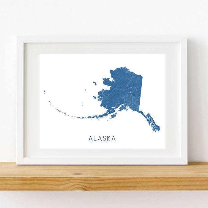 Framed map of Alaska on a white wall