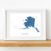 Framed map of Alaska on a white wall