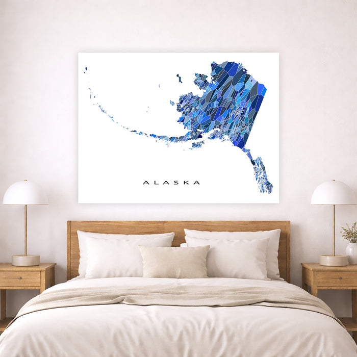 Map of Alaska on a wall above a bed in a bedroom