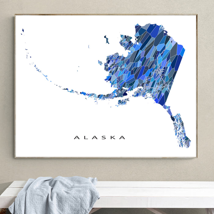 Framed map of Alaska with a geometric design on a wall.