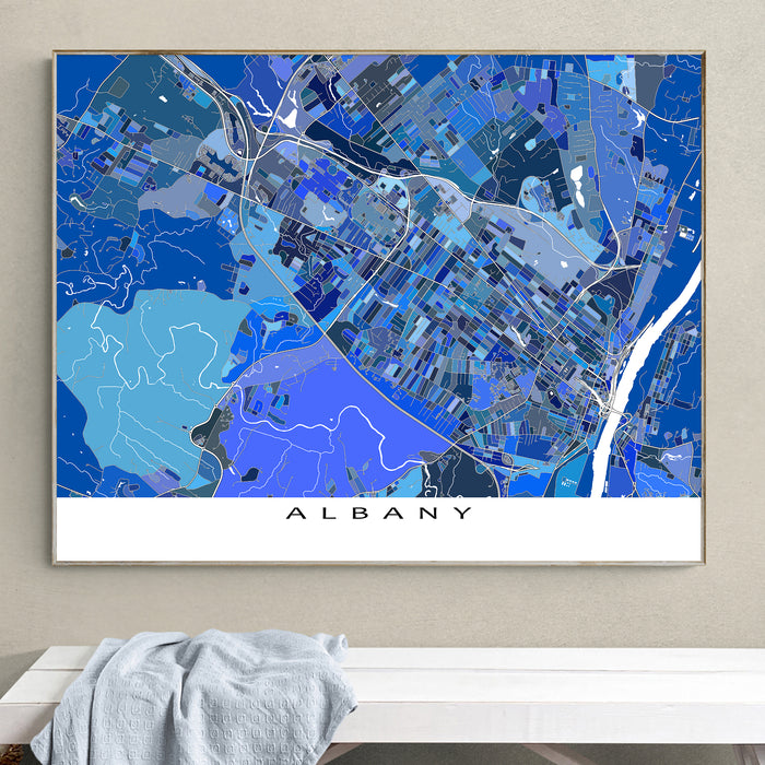 Framed map of Albany on a wall above a white surface.