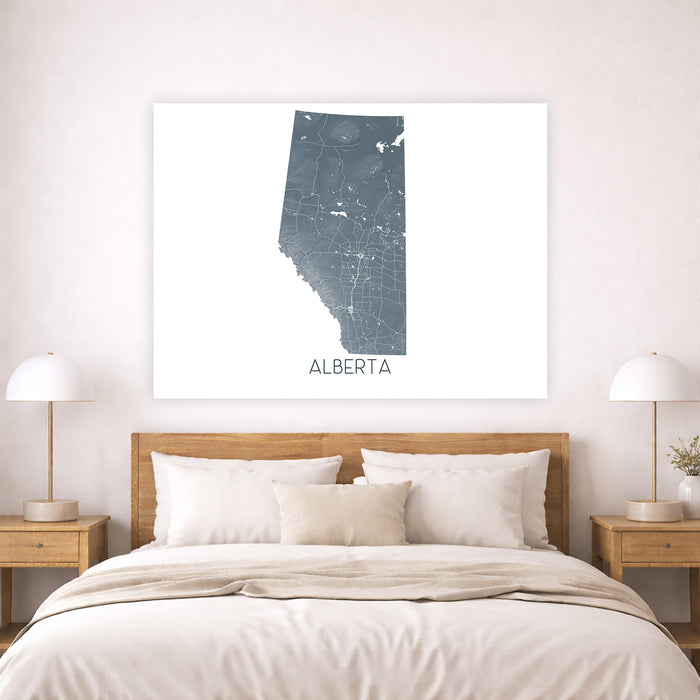 Map of Alberta on a wall above a bed in a bedroom setting