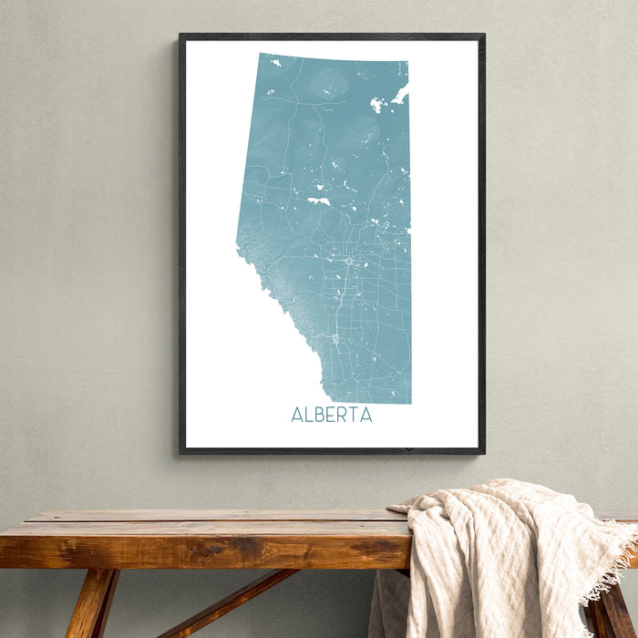Framed map of Alberta on a wall above a wooden bench.