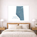 A framed wall art print showing a blue map of Alberta, Canada, displayed above a neatly made bed in a bright, modern bedroom with wooden nightstands and lamps.