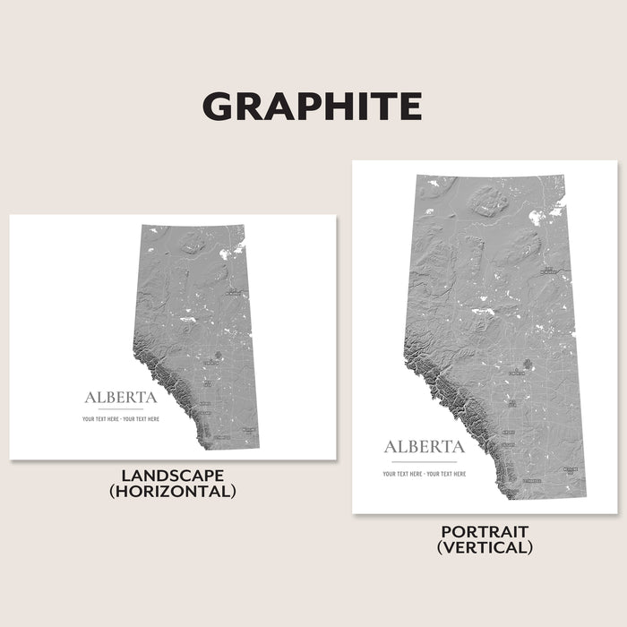Two Alberta province map art prints shown on a beige background, labeled GRAPHITE, with one landscape horizontal version and one portrait vertical version. The maps are gray on white with the word ALBERTA and small placeholder text.
