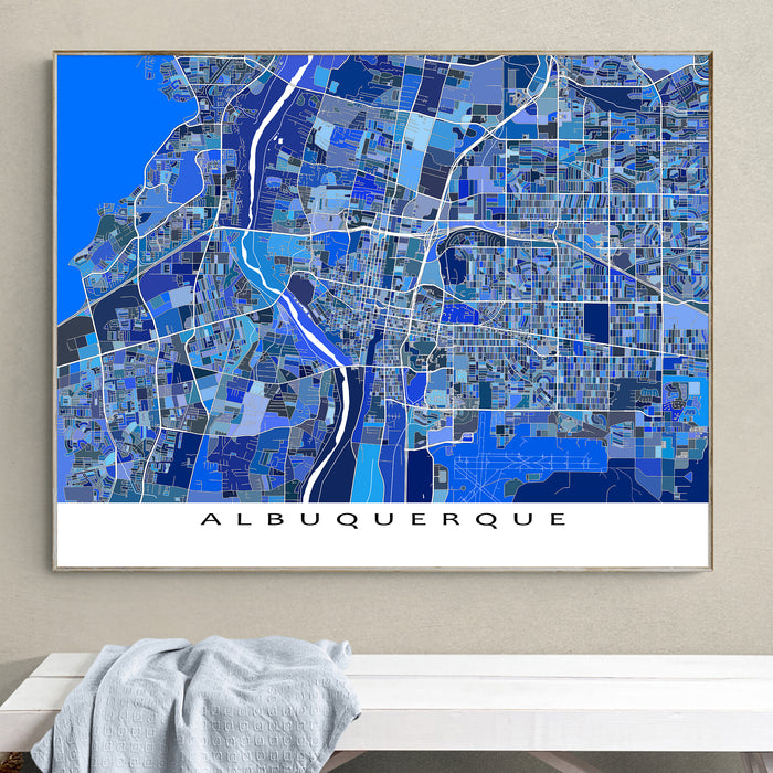 Framed map of Albuquerque on a wall above a white surface with a gray towel.