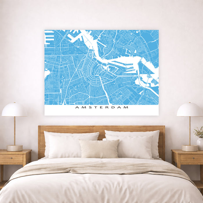 Map of Amsterdam on a wall above a bed in a bedroom setting