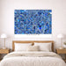 Blue mosaic map of Anaheim on a wall above a bed with wooden headboard and nightstands.