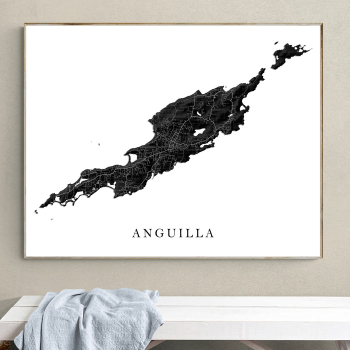Framed map of Anguilla on a wall above a white bench.