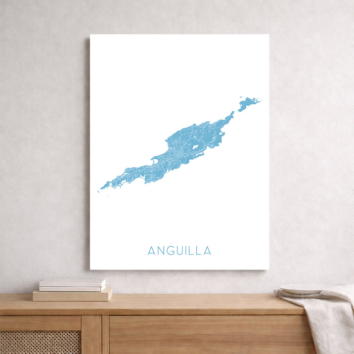 Map of Anguilla on a white wall above a wooden shelf.