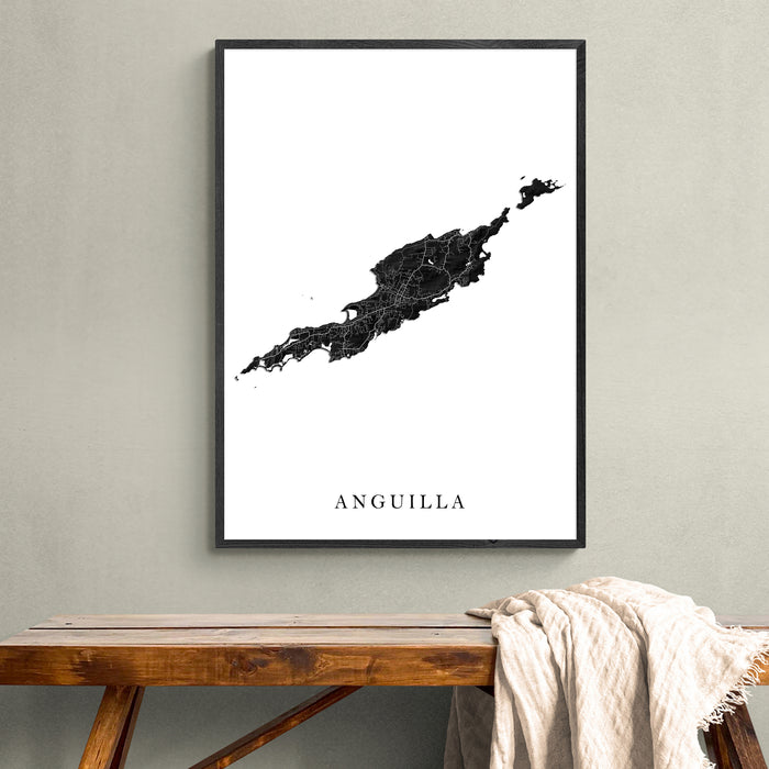 Framed map of Anguilla on a wall above a wooden bench.