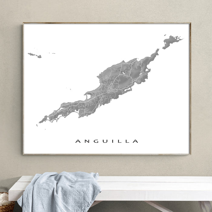 Framed map of Anguilla on a wall above a bench with a towel.