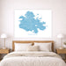 Framed map of Antigua on a wall above a bed with wooden headboard and nightstands.