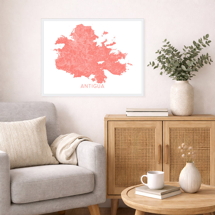 Living room with a gray sofa, wooden cabinet, and decorative items including a map of Antigua.