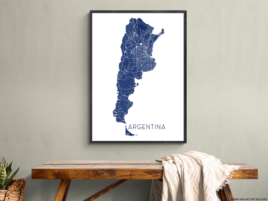 Framed map of Argentina on a wall above a wooden table.