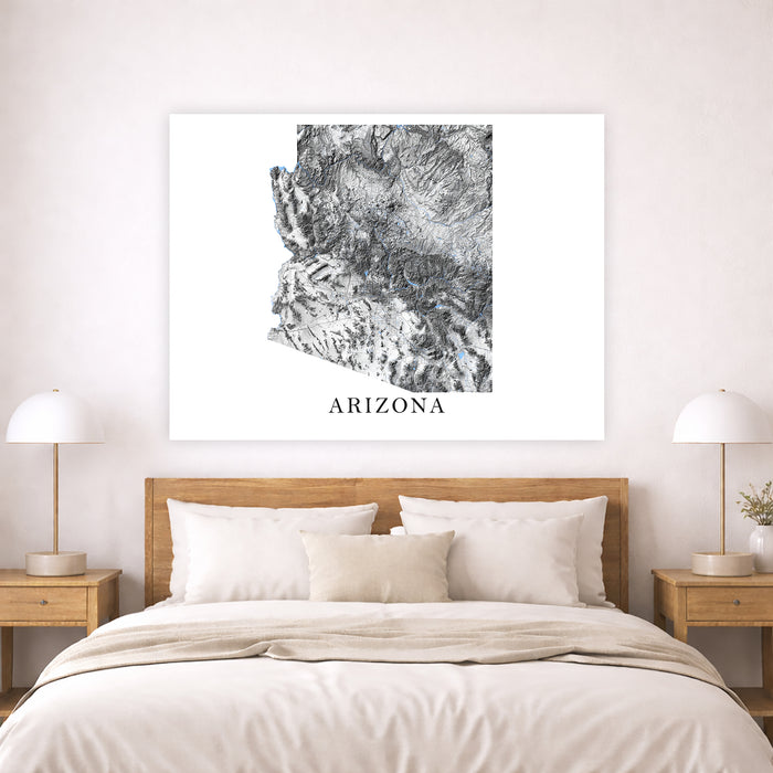 Bedroom with a wooden headboard and white bedding, featuring a framed map of Arizona on the wall.