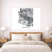 Bedroom with a wooden headboard and white bedding, featuring a framed map of Arizona on the wall.
