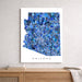 Framed mosaic map of Arizona on a wall above a wooden shelf.