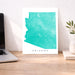 Map of Arizona on a desk with a laptop and plant